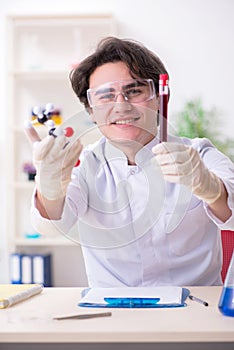 Young male biochemist working in the lab