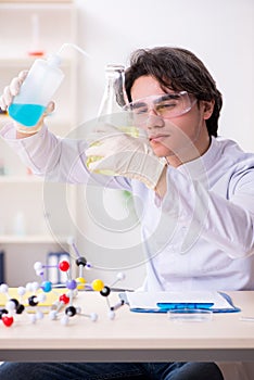 Young male biochemist working in the lab