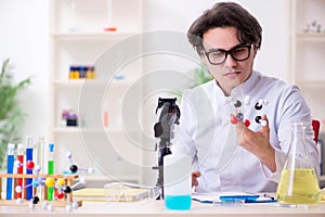 Young male biochemist working in the lab