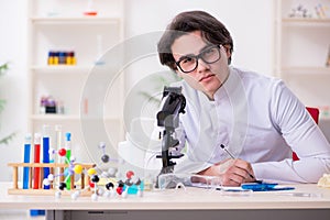 Young male biochemist working in the lab