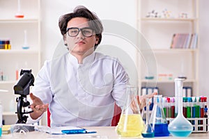 Young male biochemist working in the lab