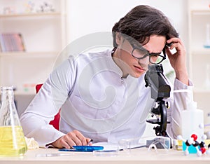 Young male biochemist working in the lab