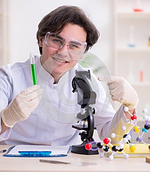 Young male biochemist working in the lab