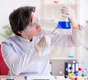 Young male biochemist working in the lab