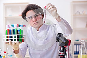 Young male biochemist working in the lab