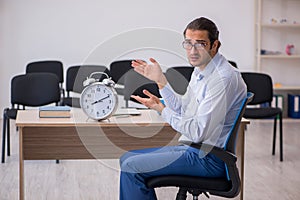 Young male boss giving seminar in the office during pandemic