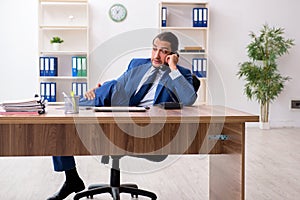 Young male businessman employee working in the office