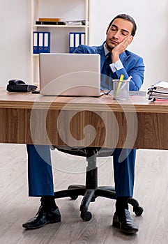 Young male businessman employee working in the office