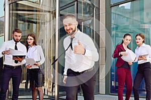 A young male businessman is enjoying a successful deal on the ba photo