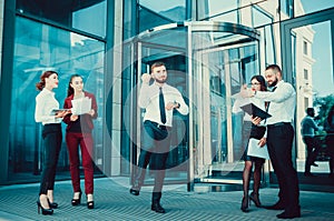 A young male businessman is enjoying a successful deal on the ba photo