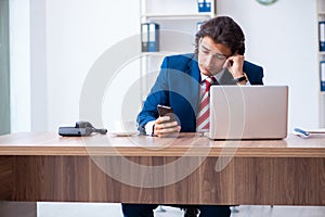 Young male businessman working in the office