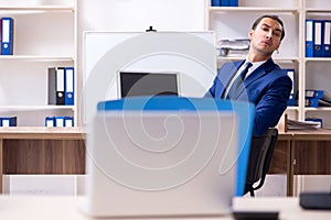 Young male businessman working in the office