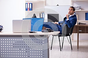 Young male businessman working in the office