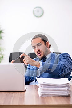 Young male businessman working in the office