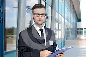 Young male call center operator in suit