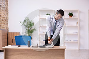 Young male call center operator working at his desk