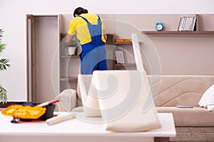 Young male carpenter stealing jewelry at home