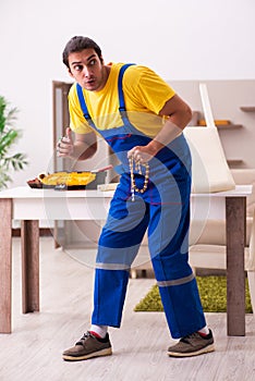 Young male carpenter stealing jewelry at home