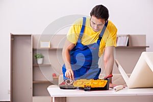 Young male carpenter stealing jewelry at home