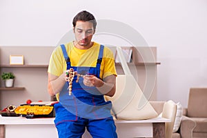 Young male carpenter stealing jewelry at home