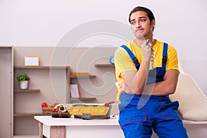 Young male carpenter stealing jewelry at home