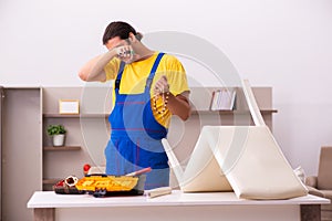 Young male carpenter stealing jewelry at home