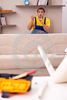 Young male carpenter stealing jewelry at home