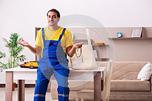 Young male carpenter stealing jewelry at home