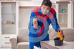 Young male carpenter stealing jewelry at home