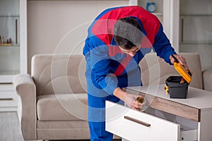 Young male carpenter stealing jewelry at home