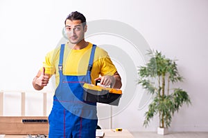 Young male carpenter working indoors