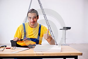 Young male carpenter working indoors