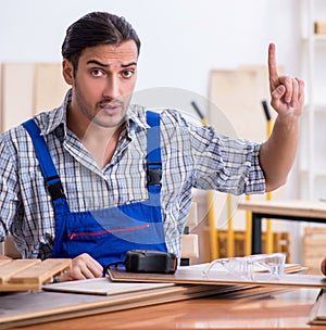 Young male carpenter working indoors