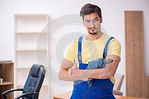 Young male carpenter working in the office