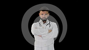 Young male Caucasian doctor standing with folded hands, Alpha Channel