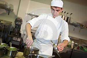 Young male chef cooking meal