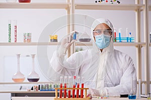 Young male chemist in drugs syntesis concept