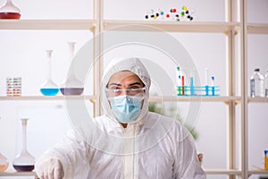 Young male chemist in drugs syntesis concept