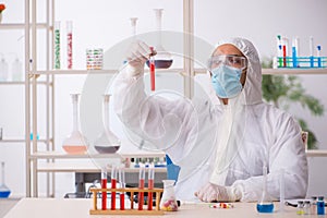 Young male chemist in drugs syntesis concept