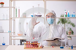 Young male chemist in drugs syntesis concept