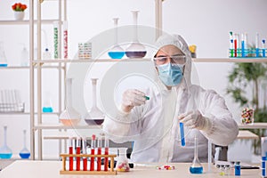 Young male chemist in drugs syntesis concept