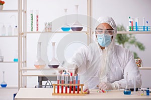 Young male chemist in drugs syntesis concept