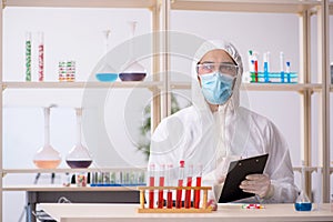 Young male chemist in drugs syntesis concept photo