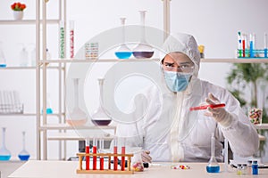 Young male chemist in drugs syntesis concept