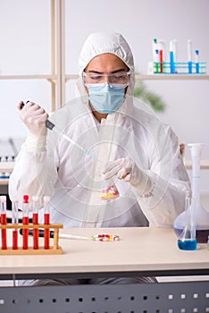 Young male chemist in drugs syntesis concept photo