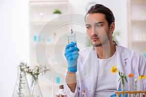 Young male chemist in perfume synthesis concept