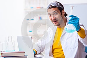 Young male chemist student preparing for exam