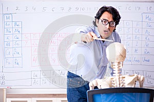 The young male chemist teacher and student skeleton