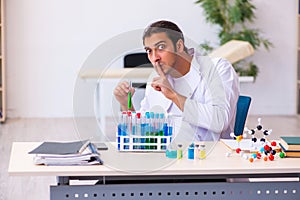 Young male chemist working in the lab