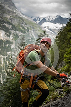 Young, male climber on a via ferrata route